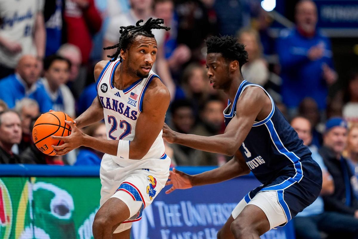  Jan 31, 2026; Lawrence, Kansas, USA; Kansas Jayhawks guard Darryn Peterson (22) looks to pass against BYU Cougars forward AJ Dybantsa (3) during the first half at Mizzou Arena. Mandatory Credit: Jay Biggerstaff-Imagn Images 