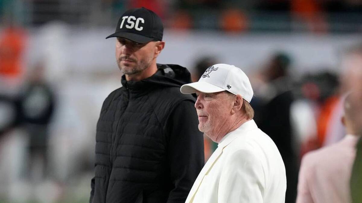  Jan 19, 2026; Miami Gardens, FL, USA; Las Vegas Raiders general manager John Spytek and owner Mark Davis look on from the sideline before the CFP National Championship college football game between the Indiana Hoosiers and the Miami Hurricanes at Hard Rock Stadium. Mandatory Credit: Kirby Lee-Imagn Images | Kirby Lee-Imagn Images 