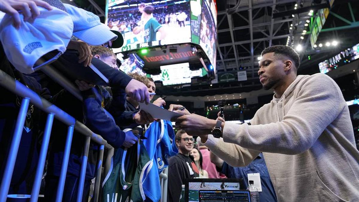  Apr 10, 2026; Milwaukee, Wisconsin, USA; Milwaukee Bucks forward Giannis Antetokounmpo (34) signs autographs for fans following the game against the Brooklyn Nets at Fiserv Forum. | Jeff Hanisch-Imagn Images 