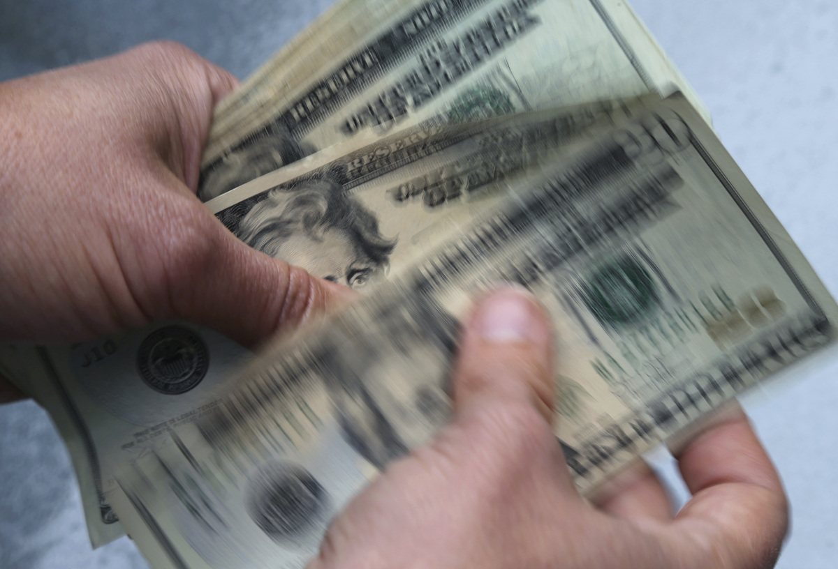  In this June 15, 2018, file photo, $20 bills are counted in North Andover, Massachusetts. (AP Photo/Elise Amendola, File) 