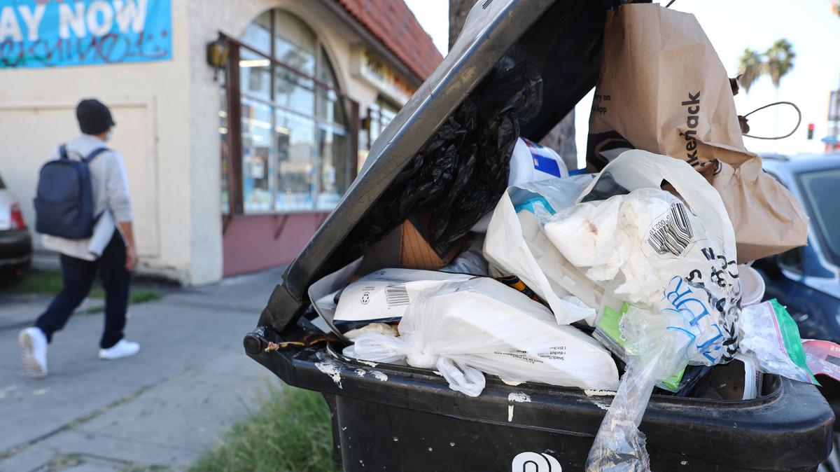 Discarded plastic and other material overflow in a garbage bin on Oct. 26, 2022, in Los Angeles.