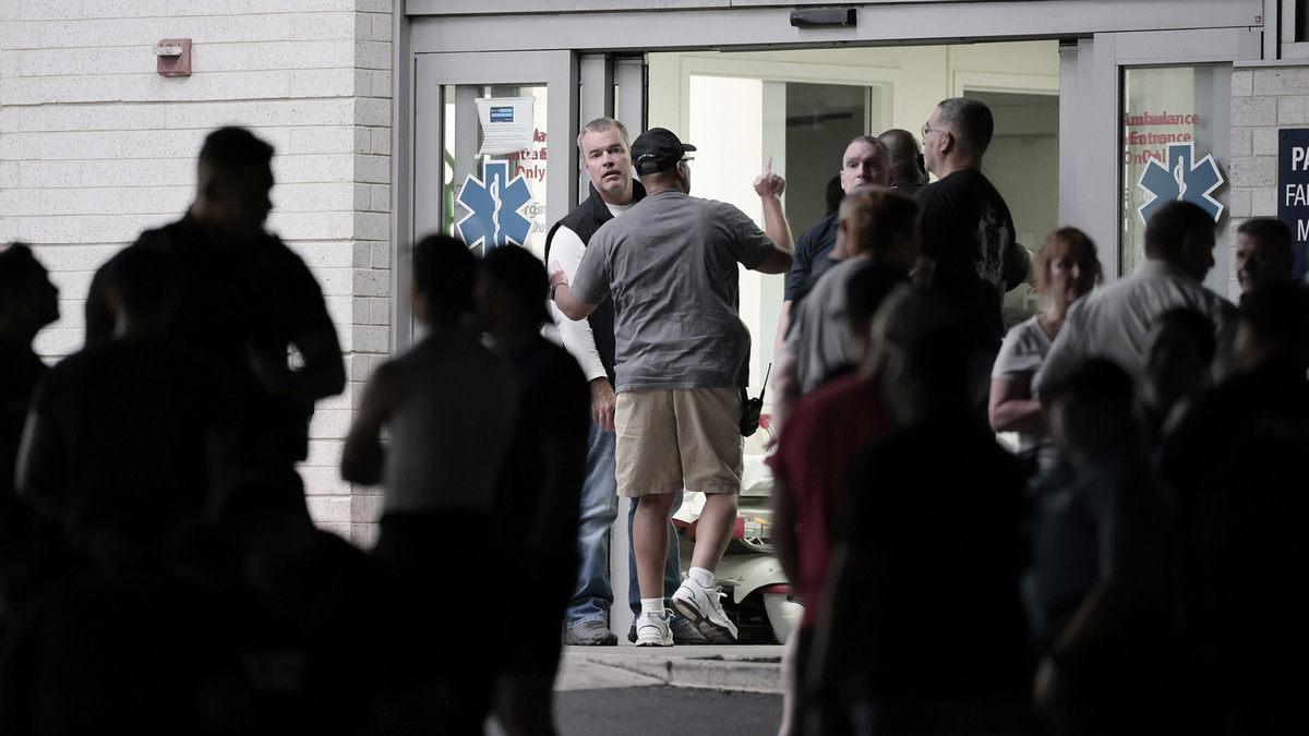 Philadelphia City Managing Director Adam K. Thiel (center, facing forward) at the emergency entrance of Penn Presbyterian Medical Center, where three Philadelphia police officers were taken after being shot. (Elizabeth Robertson/The Philadelphia Inquirer/TNS)
