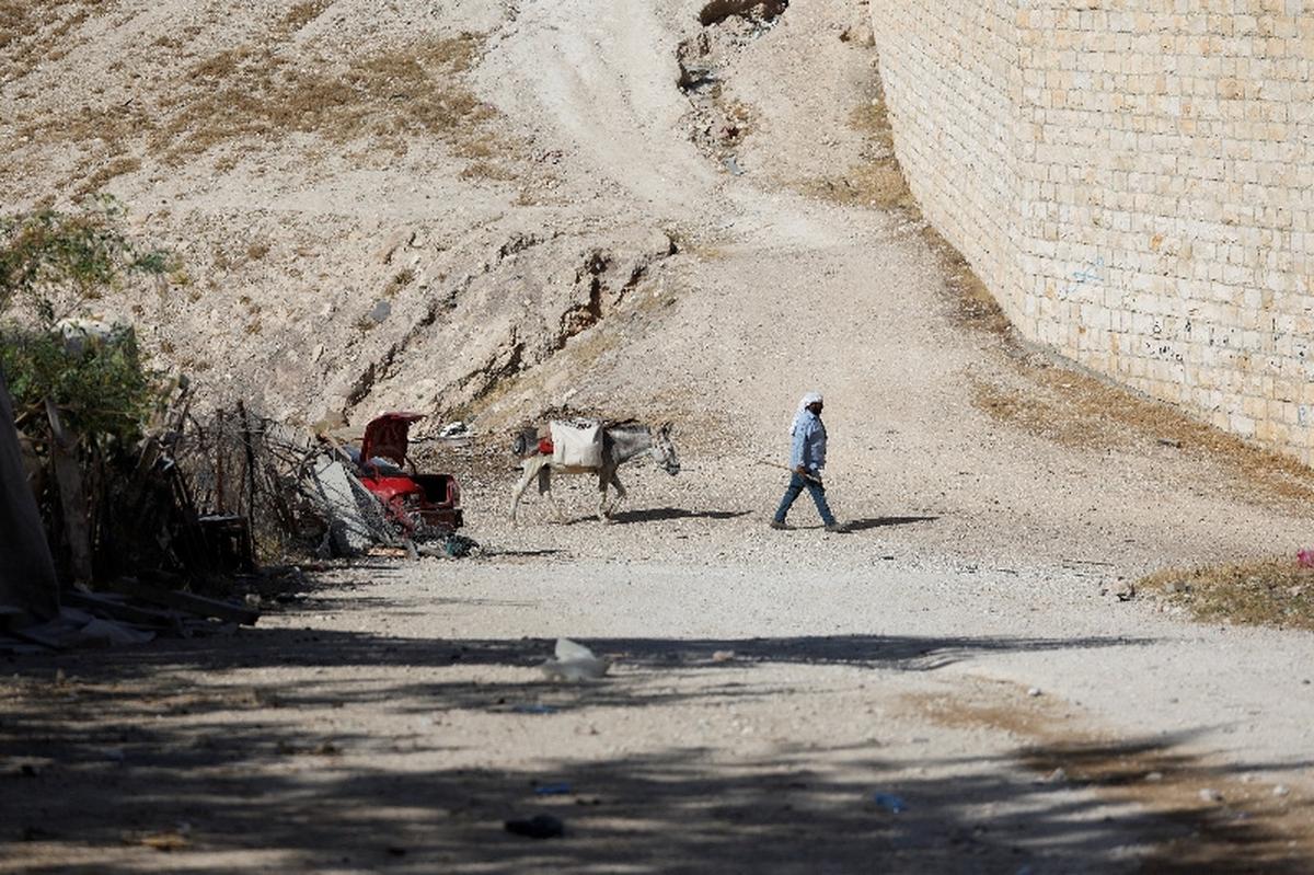 A man leads a donkey al-Khan al-Ahmar near Jericho, in the Israeli-occupied West Bank, May 19, 2026. REUTERS/Mohammed Torokman