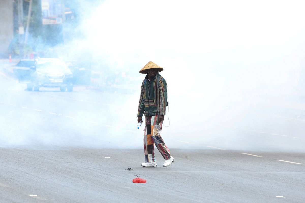 A mans stands amid tear gas used by police to disperse protesters during demonstrations to mark the second anniversary of the deadly 2024 anti-government protests, in Nairobi, Kenya, June 25, 2026. REUTERS/Monicah Mwangi