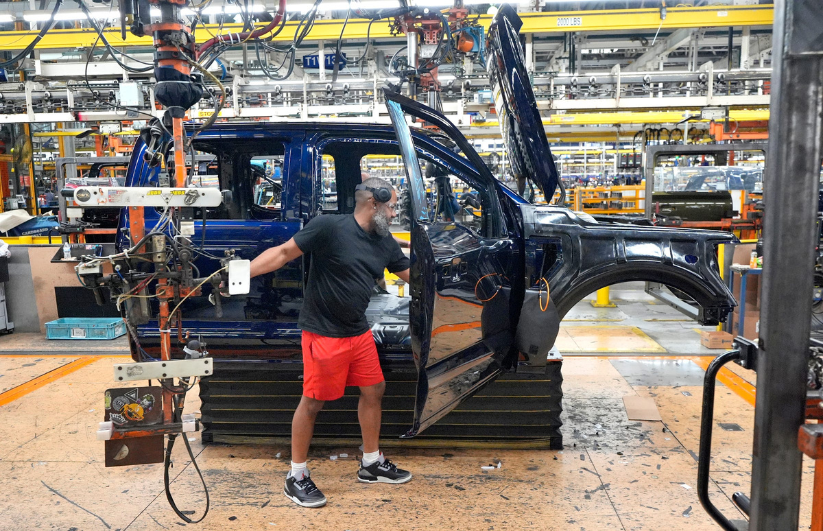 Antonio King, production floor associate at the Ford Motor Company Dearborn Truck Plant in Dearborn, works on assembling a Ford F-150 on Friday, July 18, 2025.
