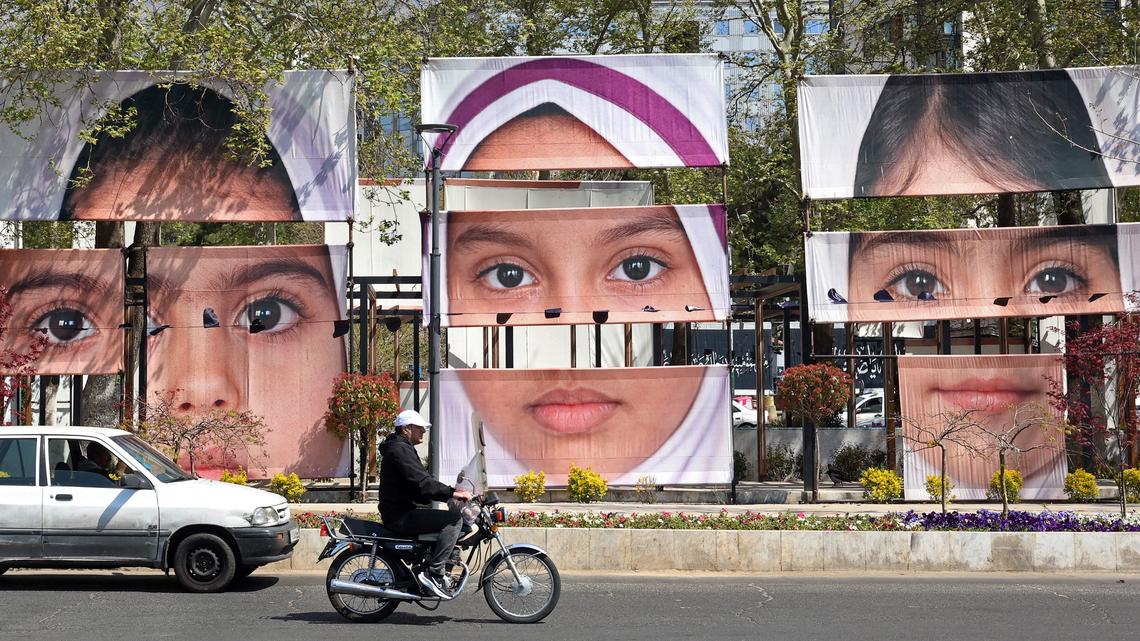 Motorists drive past the portraits of children killed in a deadly strike on a children's school in the southern city of Minab on the first day of the war that killed at least 165 people, most of them children, at the Tajrish Square in Tehran on April 16, 2026. A critical look at blockades of Iran, preventive war justification, genocidal threats and why sieges and total-war tactics pose serious moral problems.