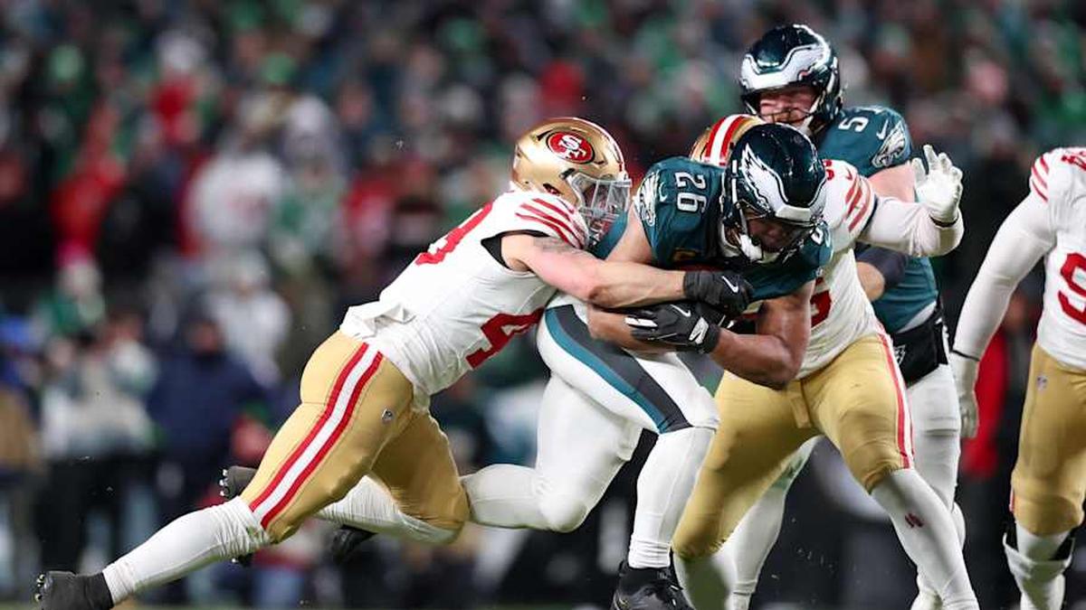  Jan 11, 2026; Philadelphia, PA, USA; Philadelphia Eagles running back Saquon Barkley (26) carries the ball defended by San Francisco 49ers linebacker Garret Wallow (49) and defensive end Keion White (56) during the third quarter in an NFC Wild Card Round game at Lincoln Financial Field. Mandatory Credit: Bill Streicher-Imagn Images | Bill Streicher-Imagn Images 