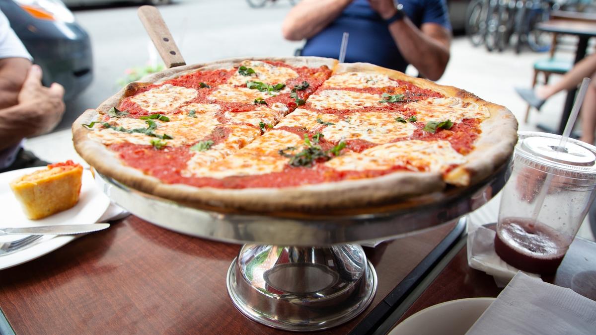NEW YORK, NEW YORK - JULY 07: A Margherita pie is served at the famous Lombardi's Pizza amid the COVID-19 pandemic on July 07, 2020 in New York, New York. In 1905, Lombardi's Pizza was recognized as the First Pizzeria in the United States. Amid the coronavirus pandemic, Lombardi's has reopened its doors once again. (Photo by Arturo Holmes/Getty Images)