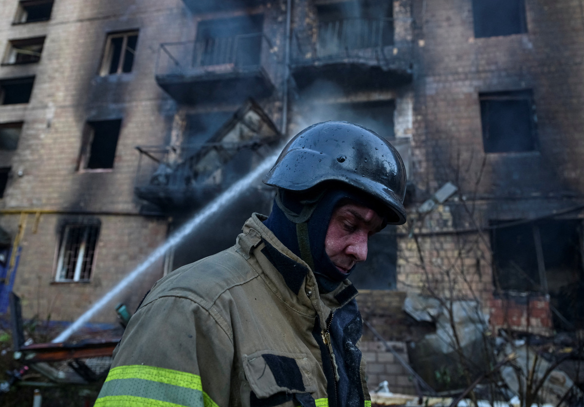 A firefighter walks near an apartment building damaged during a Russian missile and drone strike, amid Russia's attack on Ukraine, in Kyiv, Ukraine July 2, 2026. REUTERS/Viacheslav Ratynskyi