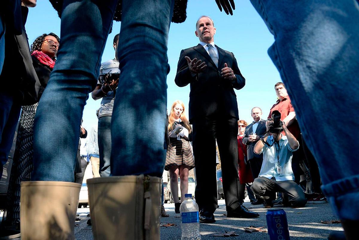 Then-University of Missouri System President Tim Wolfe addresses students involved with Concerned Student 1950 about Jonathan Butler's hunger strike on Nov. 3, 2015, in the parking lot at University Hall.