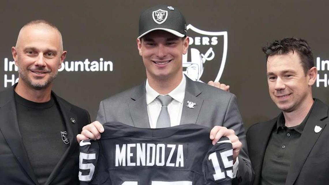  Apr 24, 2026; Henderson, NV, USA; Las Vegas Raiders quarterback Fernando Mendoza (center) poses with general manager John Spytek (left) and head coach Klint Kubiak at introductory press conference at Intermountain Health Performance Center after being selected as the No. 1 pick in the 2026 NFL Draft. Mandatory Credit: Kirby Lee-Imagn Images | Kirby Lee-Imagn Images 