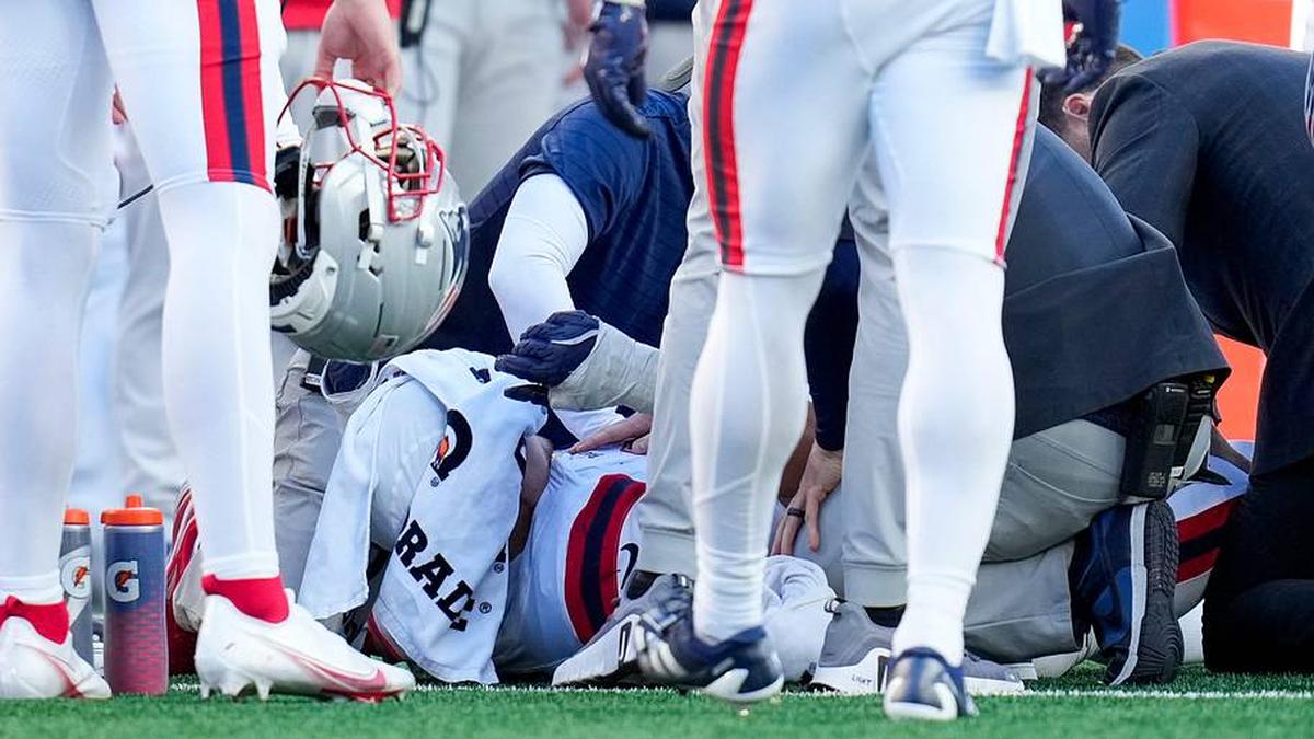  New England Patriots offensive tackle Will Campbell (66) is examined with an injury in the third quarter of the NFL Week 12 game between the Cincinnati Bengals and the New England Patriots at Paycor Stadium in downtown Cincinnati on Sunday, Nov. 23, 2025. The Bengals fall to 3-8 with a 26-20 loss at home. | Sam Greene/The Enquirer / USA TODAY NETWORK via Imagn Images 