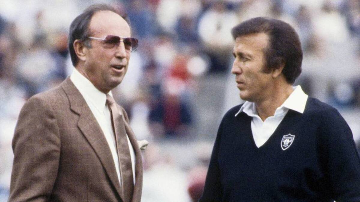  Jan 22, 1984; Tampa, FL, USA; FILE PHOTO; NFL commissioner Pete Rozelle (left) and Los Angeles Raiders head coach Tom Flores (right) talk on the field prior to Super Bowl XVIII against the Washington Redskins at Tampa Stadium. The Raiders would defeat the Redskins 38-9. Mandatory Credit: Manny Rubio-Imagn Images | Manny Rubio-Imagn Images 