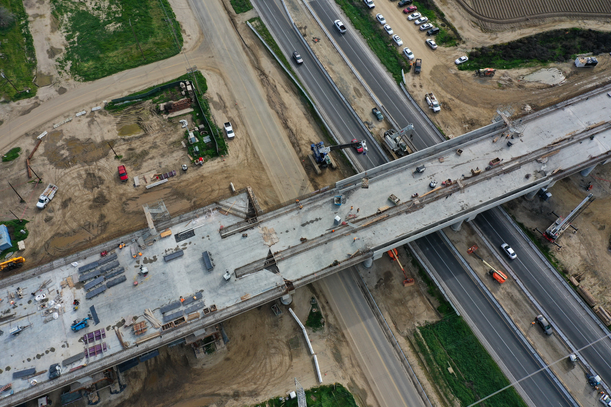  An aerial image shows construction workers building the Hanford Viaduct over Highway 198 and past agricultural fields as part of the California High Speed Rail (CAHSR) transit project in Hanford, California, on February 12, 2025. 
