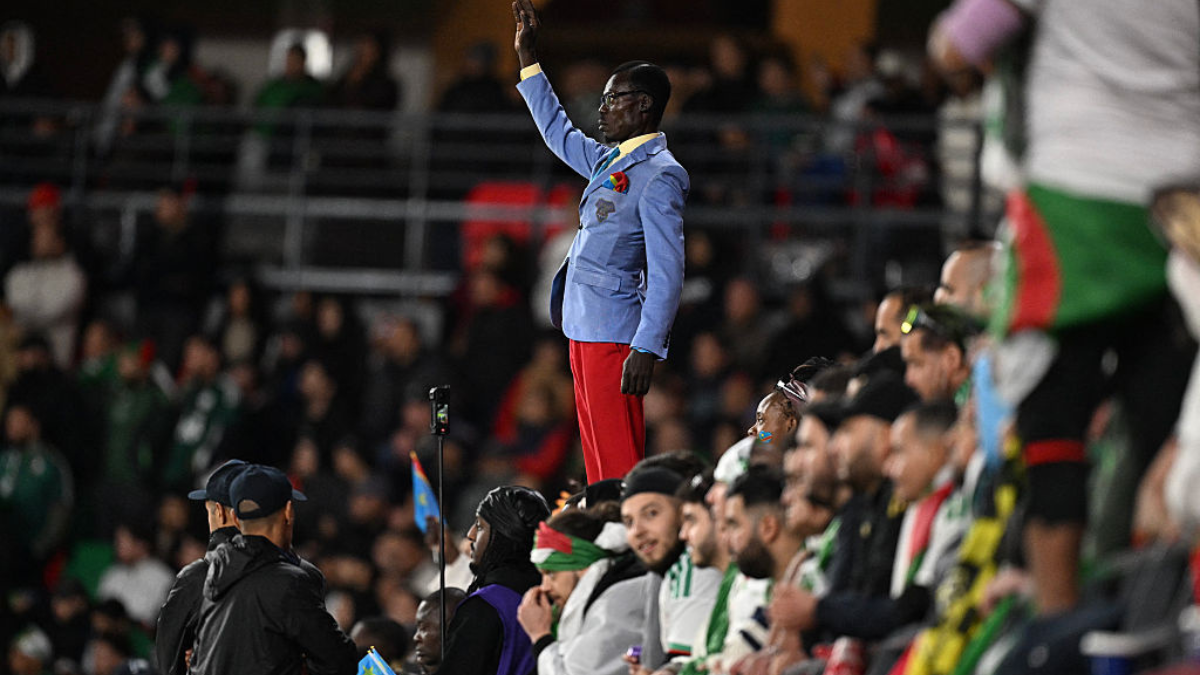 Democratic Republic of Congo's supporter Michel Kuka Mboladinga, pays tribute to Democratic Republic of Congo's late prime minister Patrice Lumumba, by remaining motionless before the Africa Cup of Nations (CAN) round of 16 football match between Algeria and Democratic Republic of Congo at the Prince Moulay El Hassan Stadium in Rabat on January 6, 2026.