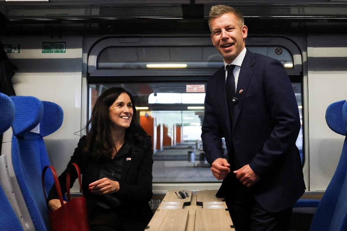 Hungary's Prime Minister Peter Magyar and Foreign Minister Anita Orban travel by train, during his first official visit, in Krakow, Poland, May 19, 2026. Picture taken through glass. REUTERS/Kacper Pempel