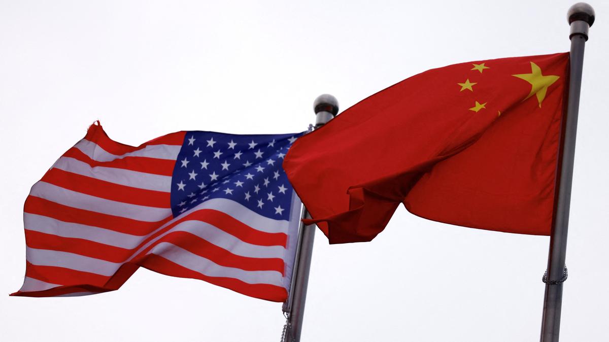 Chinese and U.S. flags flutter outside the building of an American company in Beijing, China April 8, 2025. REUTERS/Tingshu Wang/File Photo