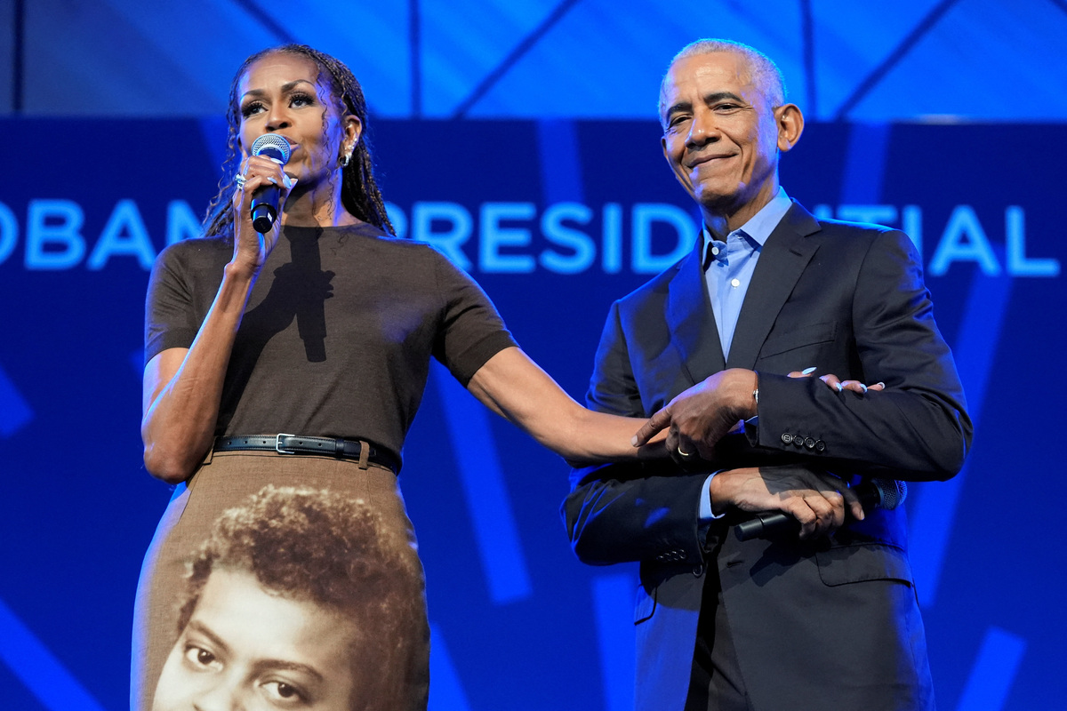 Former U.S. President Barack Obama and former U.S. first lady Michelle Obama hold hands as they deliver remarks at a stakeholders event at the Obama Presidential Centre in Chicago, Illinois, U.S., June 16, 2026. Pablo Martinez Monsivais/Pool via REUTERS