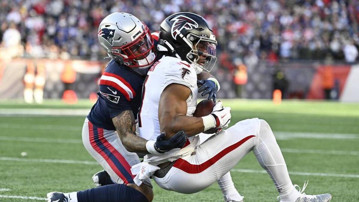  Nov 2, 2025; Foxborough, Massachusetts, USA; New England Patriots cornerback Christian Gonzalez (0) tackles Atlanta Falcons running back Bijan Robinson (7) during the third quarter at Gillette Stadium. Mandatory Credit: Eric Canha-Imagn Images | Eric Canha-Imagn Images 