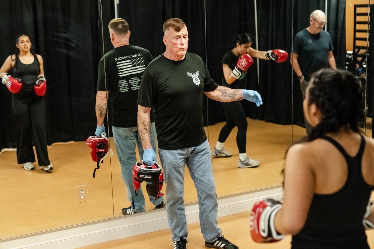 Harvard Boxing Club coach Joe Lake instructs Jacqueline Pena Gomez and her teammate Muskaan Sandhu before their sparring match during a boxing exhibition at Babson College in Wellesley, Mass., April 24, 2026. Boxing clubs at Harvard and other colleges are drawing new members as students look for a real-life connection. (Sophie Park/The New York Times)