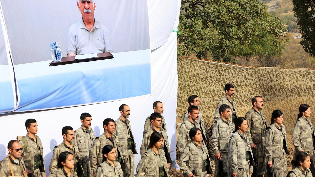 FILE PHOTO: Fighters with the Kurdistan Workers' Party (PKK) line up during a disarmament ceremony marking a significant step toward ending the decades-long conflict between Turkey and the outlawed group in Qandil mountains, Iraq October 26, 2025. REUTERS/Thaier Al-Sudani/File Photo
