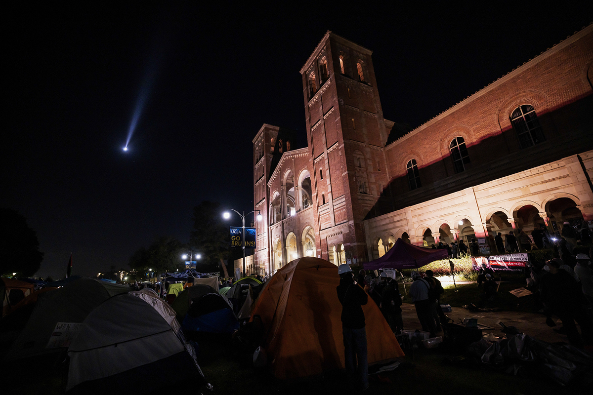 A helicopter flies over a pro-Palestinian encampment at UCLA on May 1, 2024. Groups of student protesters gathered at the encampment.