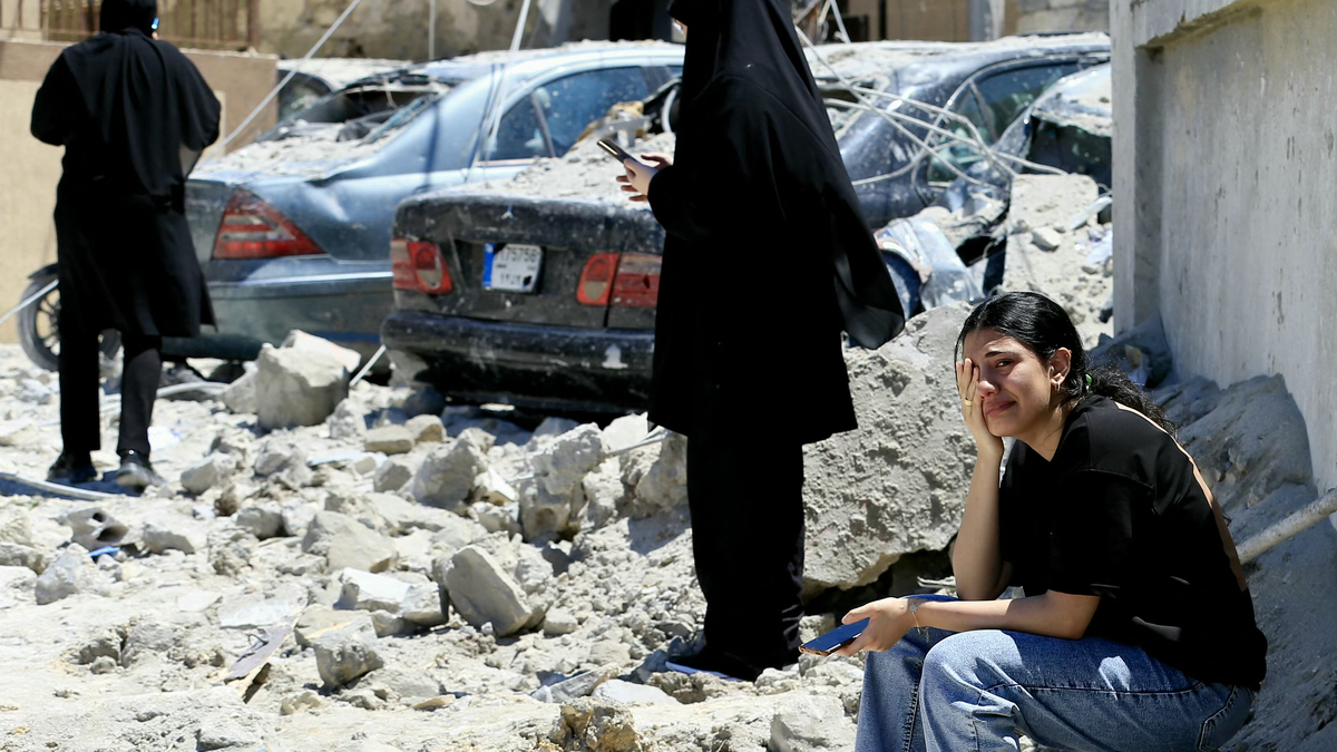 A Lebanese woman weeps as she sits among the rubble at the site of an Israeli airstrike that targeted the southern Lebanese village of Qennarit on Saturday, June 20, 2026. (AFP/Getty Images/TNS)