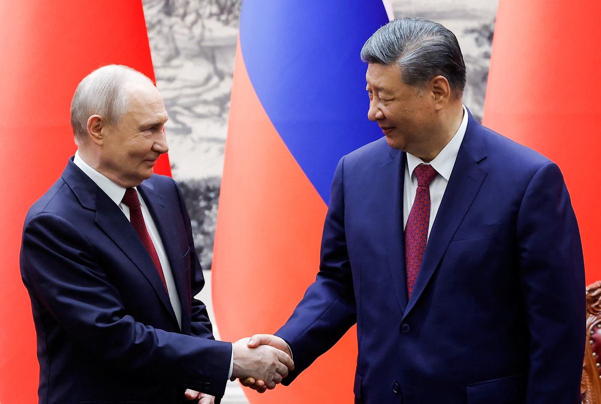 Russian President Vladimir Putin and Chinese President Xi Jinping shake hands during a signing ceremony at the Great Hall of the People in Beijing, China May 20, 2026. REUTERS/Maxim Shemetov/Pool