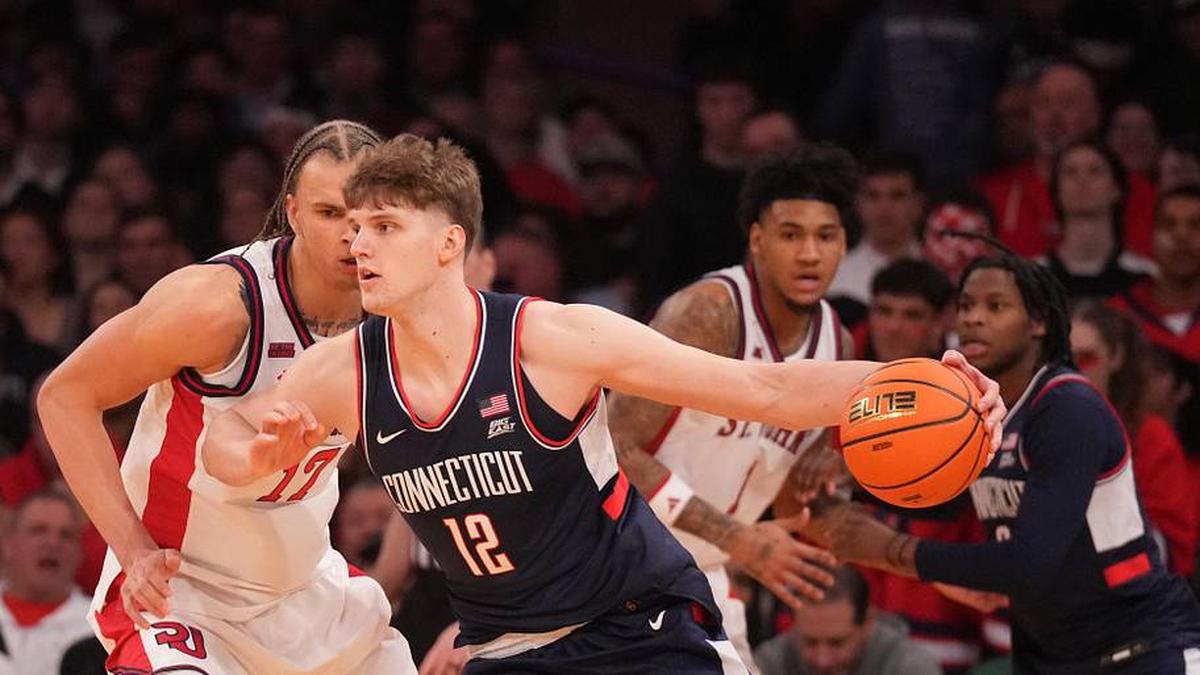  Mar 14, 2026; New York, NY, USA; Connecticut Huskies center Eric Reibe (12) works around St. John's Red Storm forward Rubén Prey (17) during the first half of the men's Big East Conference Tournament Championship at Madison Square Garden. Mandatory Credit: Robert Deutsch-Imagn Images | Robert Deutsch-Imagn Images 