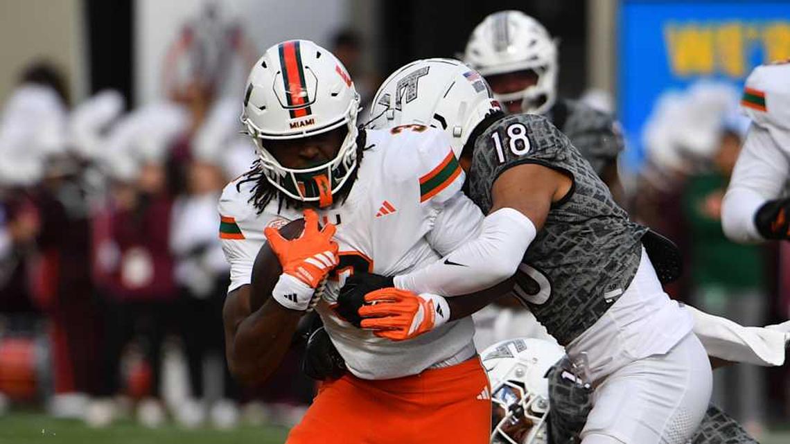  Nov 22, 2025; Blacksburg, Virginia, USA; Miami (FL) Hurricanes wide receiver Joshua Moore (3) runs after a catch as Virginia Tech Hokies safety Isaiah Cash (18) attempts to tackle during the second quarter at Lane Stadium. Mandatory Credit: Brian Bishop-Imagn Images | Brian Bishop-Imagn Images 