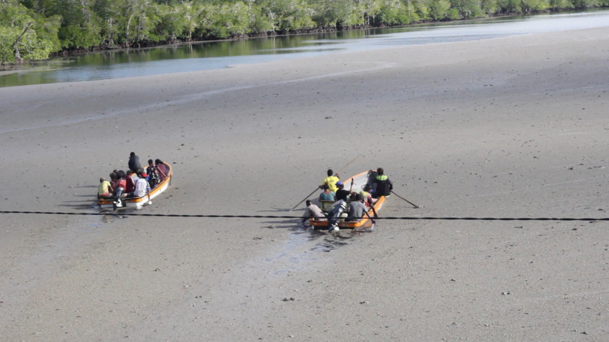Locals raft through the pumice-covered Loniu Passage, following an undersea eruption, in Manus Province, Papua New Guinea, June 8, 2026, in this screengrab obtained from a social media video. Bellamy Popot/via REUTERS