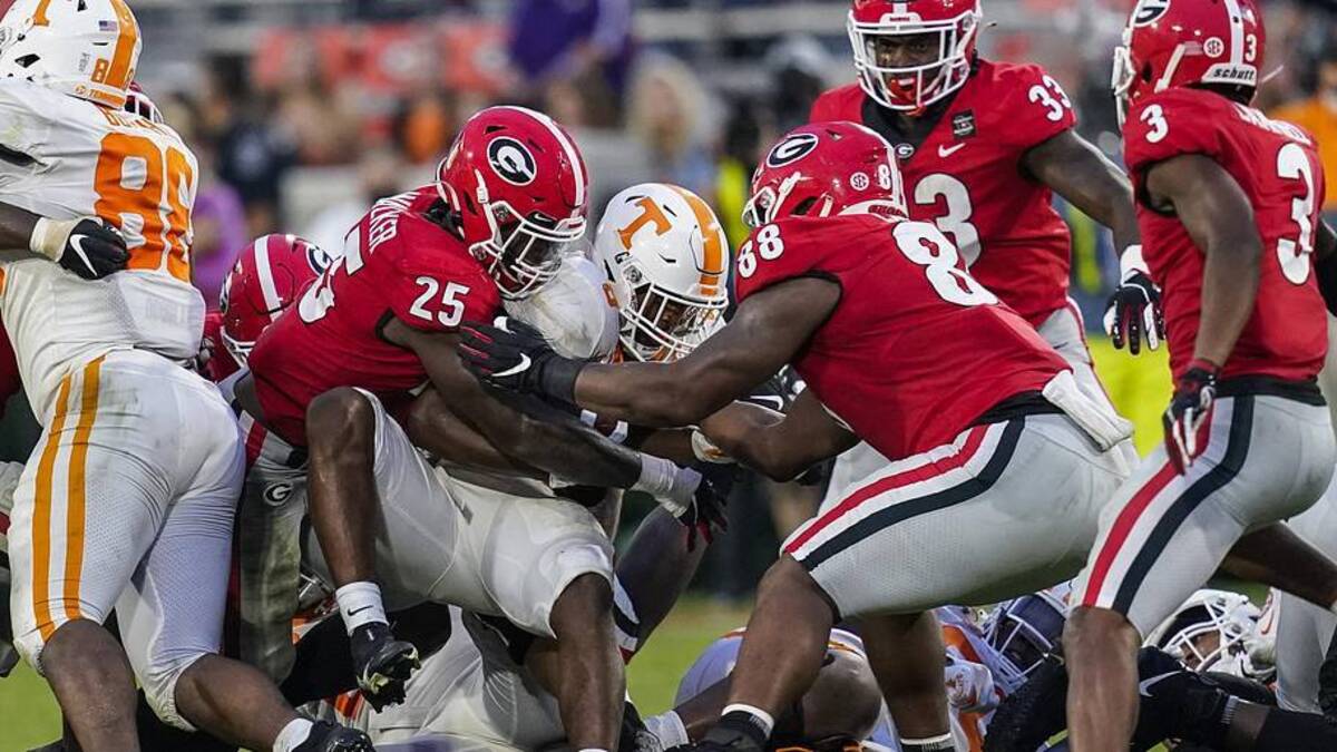  Oct 10, 2020; Athens, Georgia, USA; Georgia Bulldogs linebacker Quay Walker (25) with help from defensive lineman Jalen Carter (88) tackles Tennessee Volunteers running back Ty Chandler (8) during the second half at Sanford Stadium. Mandatory Credit: Dale Zanine-Imagn Images | Dale Zanine-Imagn Images 