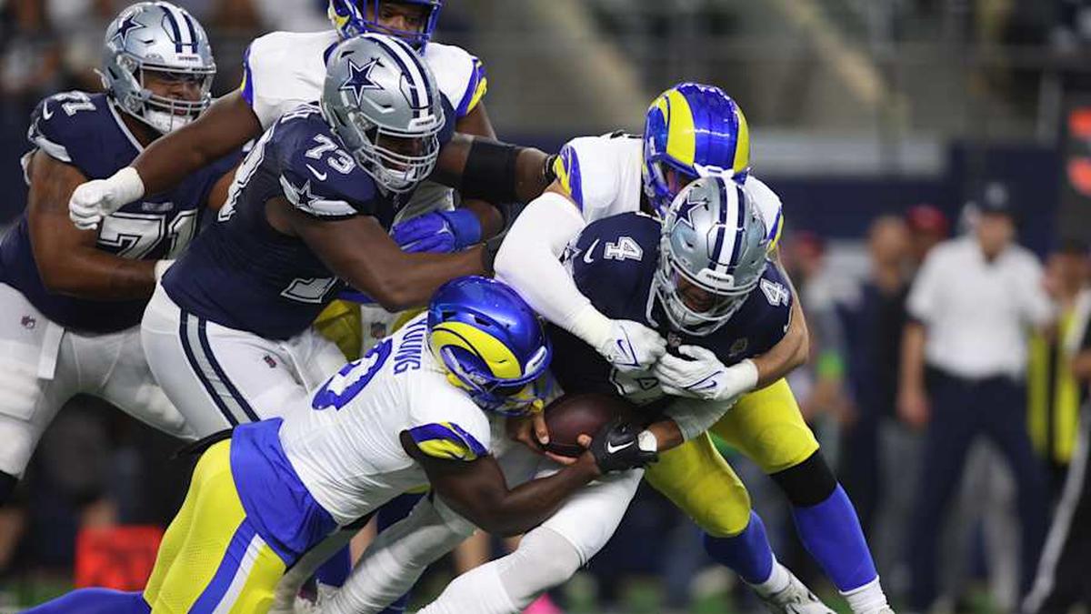  Oct 29, 2023; Arlington, Texas, USA; Dallas Cowboys quarterback Dak Prescott (4) is sacked by Los Angeles Rams linebacker Byron Young (0) and linebacker Michael Hoecht (97) in the first quarter at AT&T Stadium. Mandatory Credit: Tim Heitman-Imagn Images | Tim Heitman-Imagn Images 