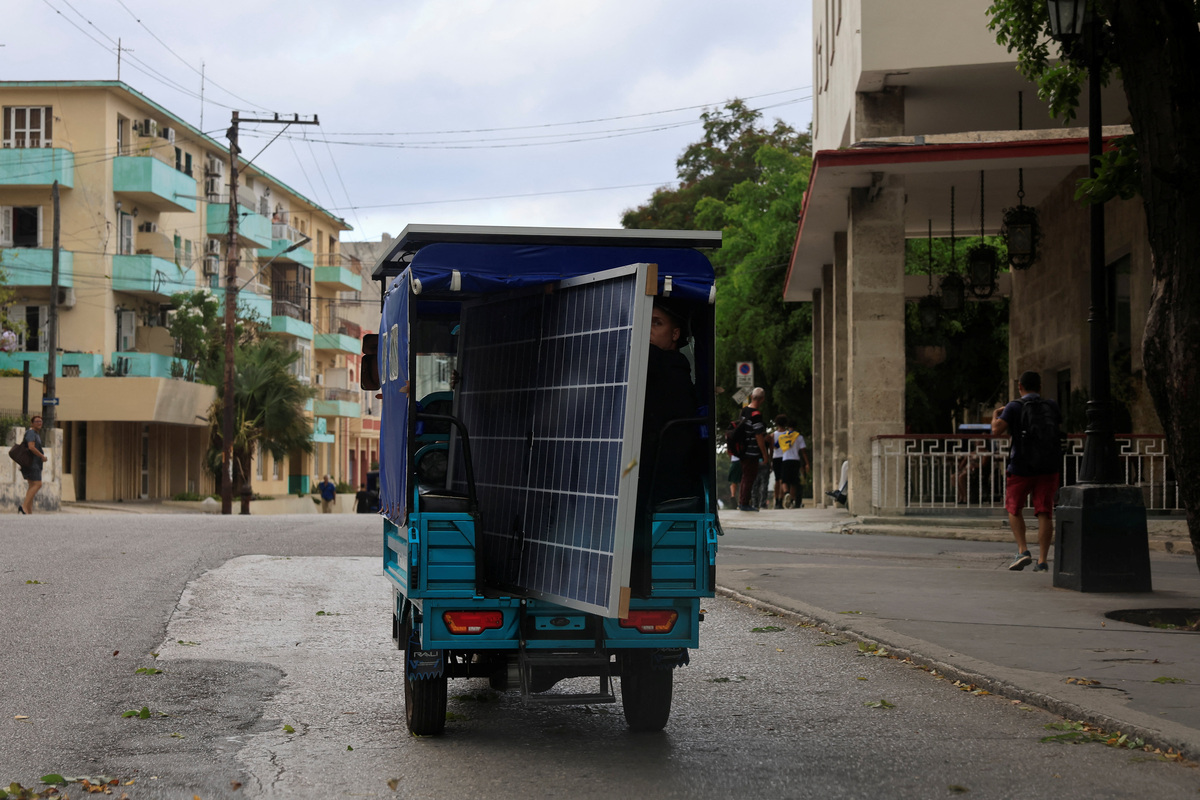 A man transports a solar panel on an electric tricycle as Cuba's national electric grid collapsed at midday, leaving around 10 million people without power, in Havana, Cuba July 6, 2026. REUTERS/Norlys Perez