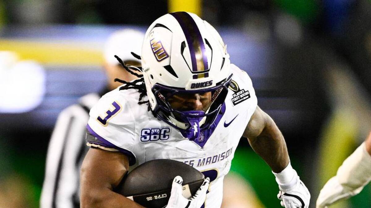  Dec 20, 2025; Eugene, OR, USA; James Madison Dukes running back Wayne Knight (3) rushes as Oregon Ducks defensive back Aaron Flowers (21) defends during the second quarter at Autzen Stadium. Mandatory Credit: Troy Wayrynen-Imagn Images | Troy Wayrynen-Imagn Images 