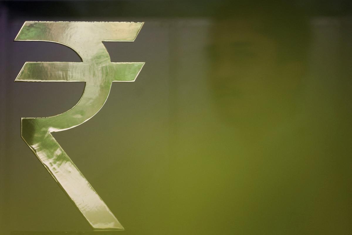 FILE PHOTO: A man walks past a Rupee installation at the Reserve Bank Of India (RBI) headquarters in Mumbai, India, April 8, 2026. REUTERS/Francis Mascarenhas/File Photo