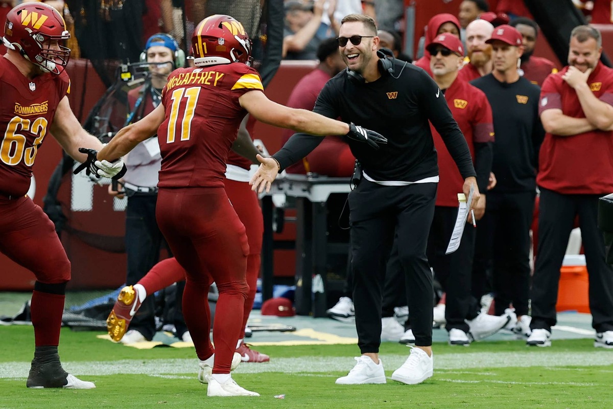  Sep 21, 2025; Landover, Maryland, USA; Washington Commanders wide receiver Luke McCaffrey (11) celebrates with Commanders offensive coordinator Kliff Kingsbury (R) after scoring a touchdown against the Las Vegas Raiders at Northwest Stadium. Mandatory Credit: Geoff Burke-Imagn Images