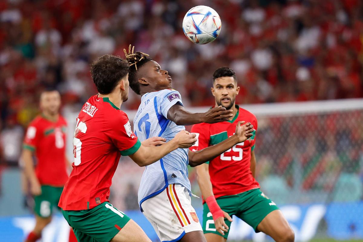  Spain forward Nico Williams (12) controls the ball against Morocco forward Abde Ezzalzouli (16). Yukihito Taguchi-USA TODAY Sports