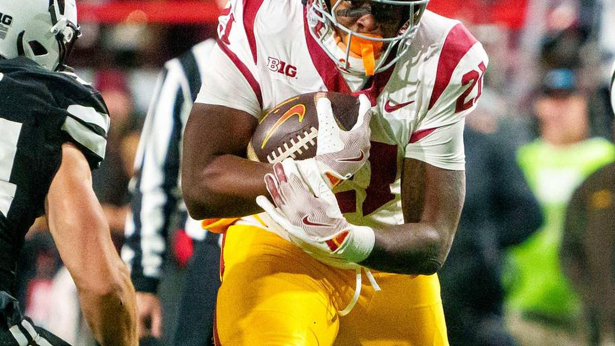  Nov 1, 2025; Lincoln, Nebraska, USA; Southern California Trojans running back Bryan Jackson (21) runs against Nebraska Cornhuskers linebacker Jacob Bower (54) and defensive lineman Keona Davis (97) during the fourth quarter at Memorial Stadium. Mandatory Credit: Dylan Widger-Imagn Images | Dylan Widger-Imagn Images 
