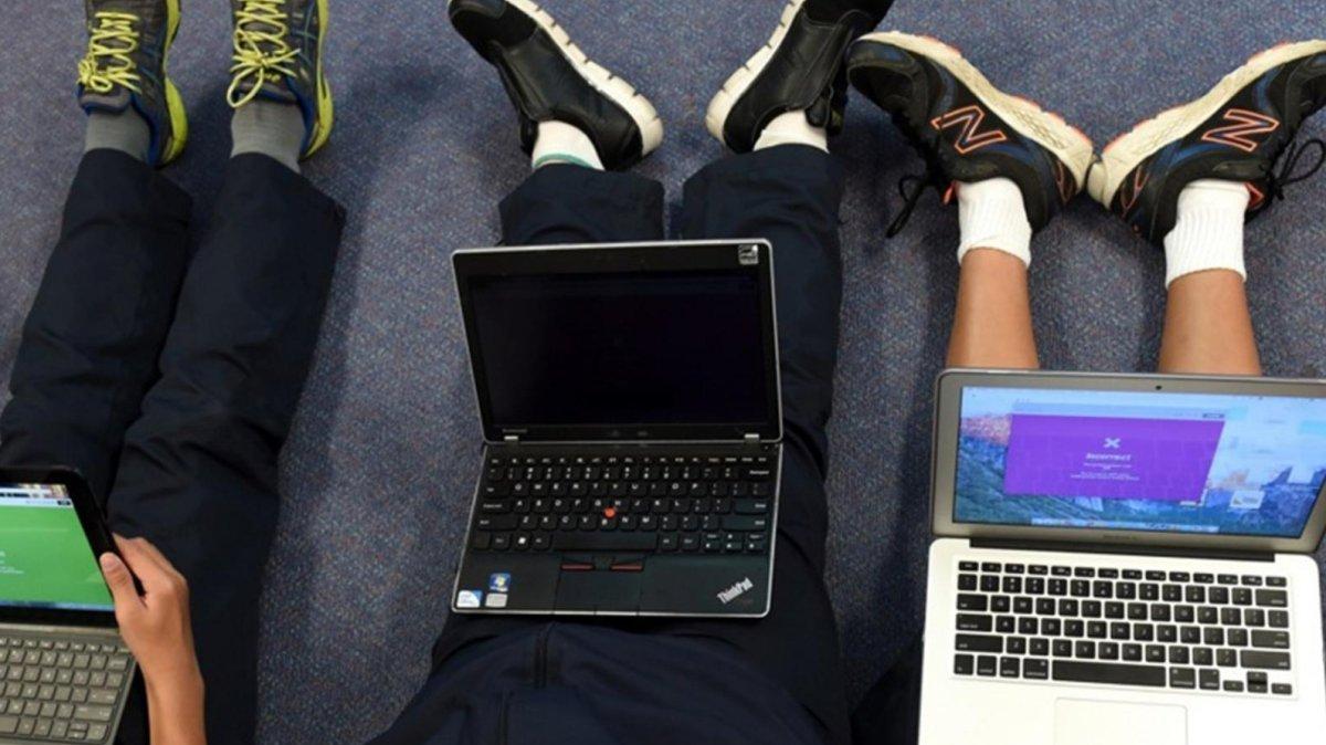Students with their computers at School. File. Photo by PAUL MILLER / EPA