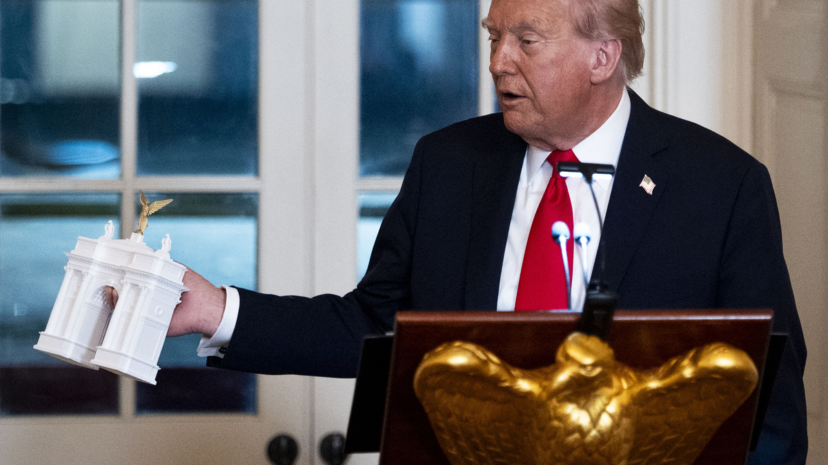 FILE -- President Donald Trump holds a model of his proposed "Independence Arch" during a fundraising dinner in the East Room of the White House in Washington, Oct, 16, 2025. President Trump's plan to build a 250-foot arch in Washington is up for review on Thursday by a federal planning commission, which will consider whether the structure could disrupt flight patterns or violate laws restricting the height of buildings in the nation's capital. (Doug Mills/The New York Times)