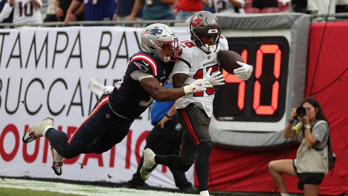  Nov 9, 2025; Tampa, Florida, USA; Tampa Bay Buccaneers wide receiver Tez Johnson (15) catches a pass for a touchdown under pressure from New England Patriots safety Craig Woodson (31) during the fourth quarter at Raymond James Stadium. Mandatory Credit: Nathan Ray Seebeck-Imagn Images | Nathan Ray Seebeck-Imagn Images 