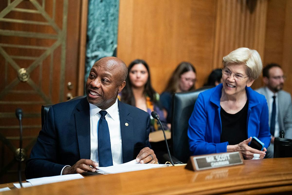  Sen. Tim Scott, R-S.C., and Sen. Elizabeth Warren, D-Mass., attend a Senate Banking Committee markup of a proposed housing bill in July 2025. Tom Williams/CQ-Roll Call via Getty Images 