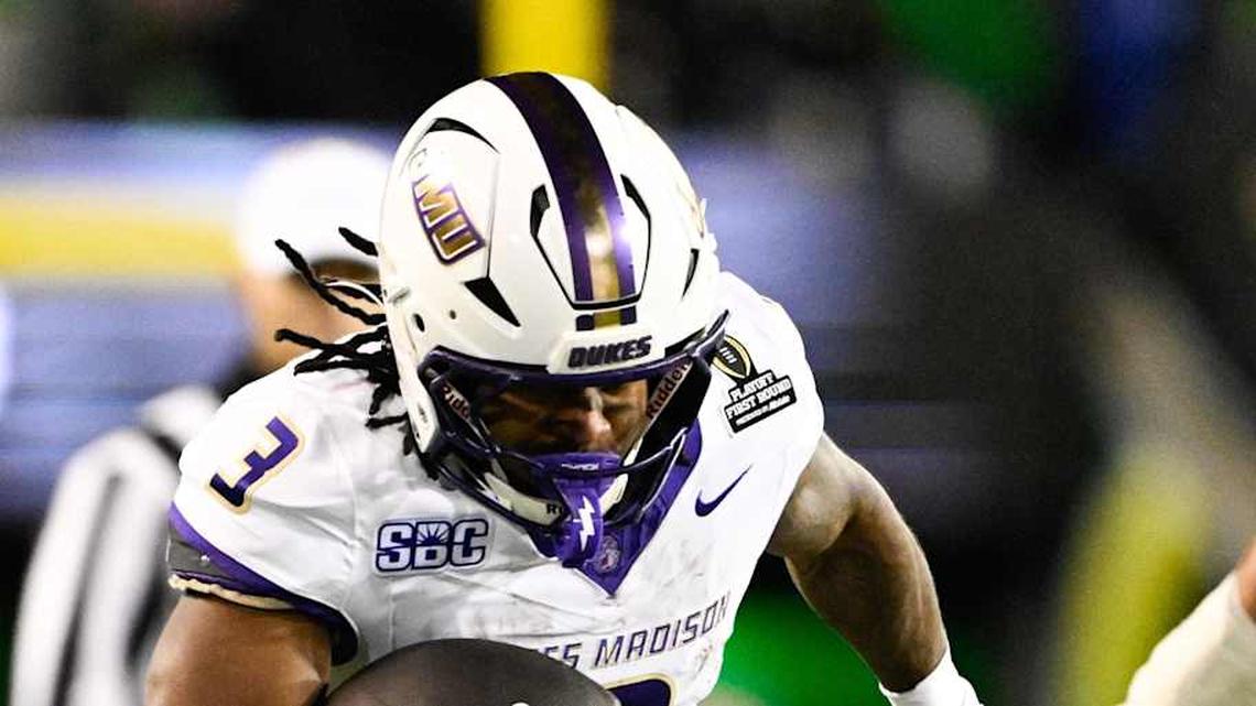  Dec 20, 2025; Eugene, OR, USA; James Madison Dukes running back Wayne Knight (3) rushes as Oregon Ducks defensive back Aaron Flowers (21) defends during the second quarter at Autzen Stadium. Mandatory Credit: Troy Wayrynen-Imagn Images | Troy Wayrynen-Imagn Images 