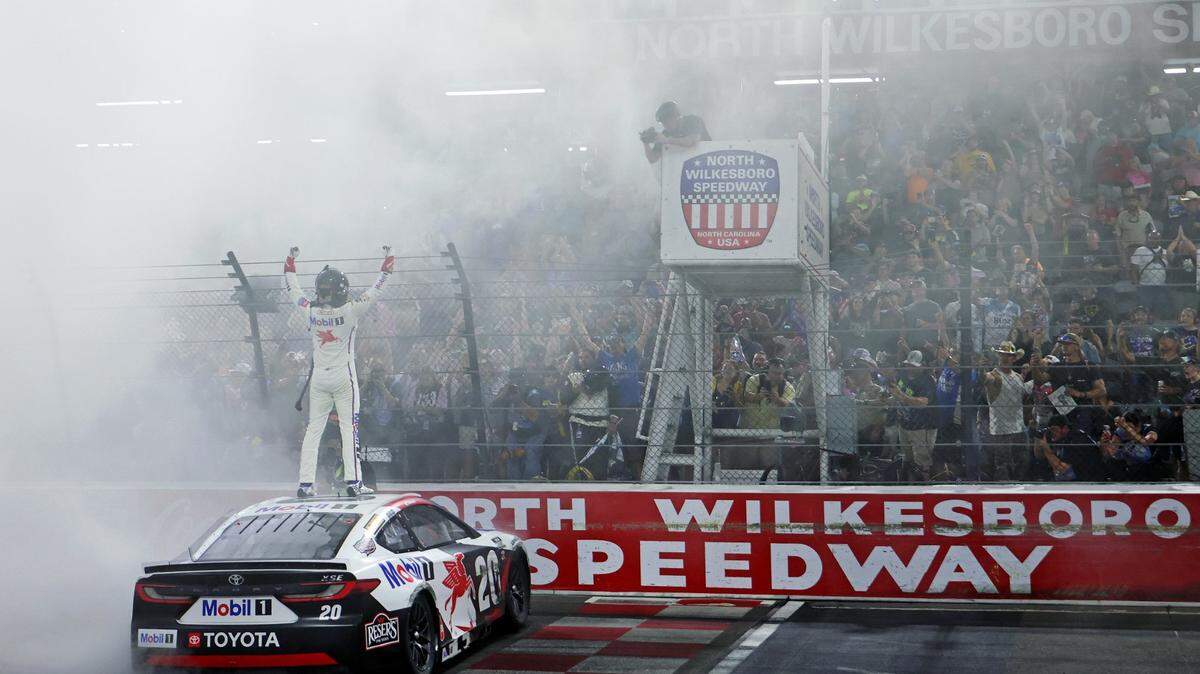 May 18, 2025; North Wilkesboro, North Carolina, USA; NASCAR Cup Series driver Christopher Bell (20) celebrates winning the NASCAR All-Star Race at North Wilkesboro Speedway.