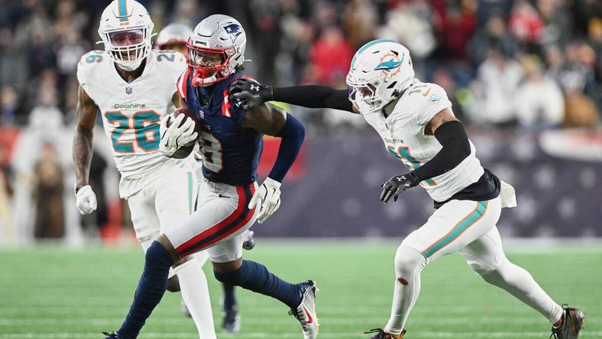  Jan 4, 2026; Foxborough, Massachusetts, USA; New England Patriots wide receiver Stefon Diggs (8) runs after the catch against Miami Dolphins safety Dante Trader Jr. (11) and cornerback Rasul Douglas (26) during the fourth quarter at Gillette Stadium. Mandatory Credit: Brian Fluharty-Imagn Images | Brian Fluharty-Imagn Images 