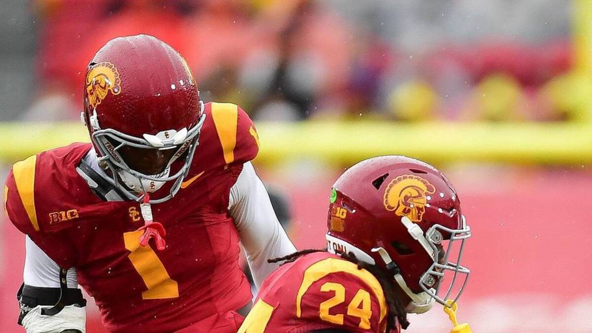  Nov 15, 2025; Los Angeles, California, USA; Iowa Hawkeyes running back Kamari Moulton (28) runs the ball against Southern California Trojans defensive end Kameryn Crawford (1) safety Christian Pierce (24) and cornerback Decarlos Nicholson (17) during the first half at the Los Angeles Memorial Coliseum. Mandatory Credit: Gary A. Vasquez-Imagn Images | Gary A. Vasquez-Imagn Images 