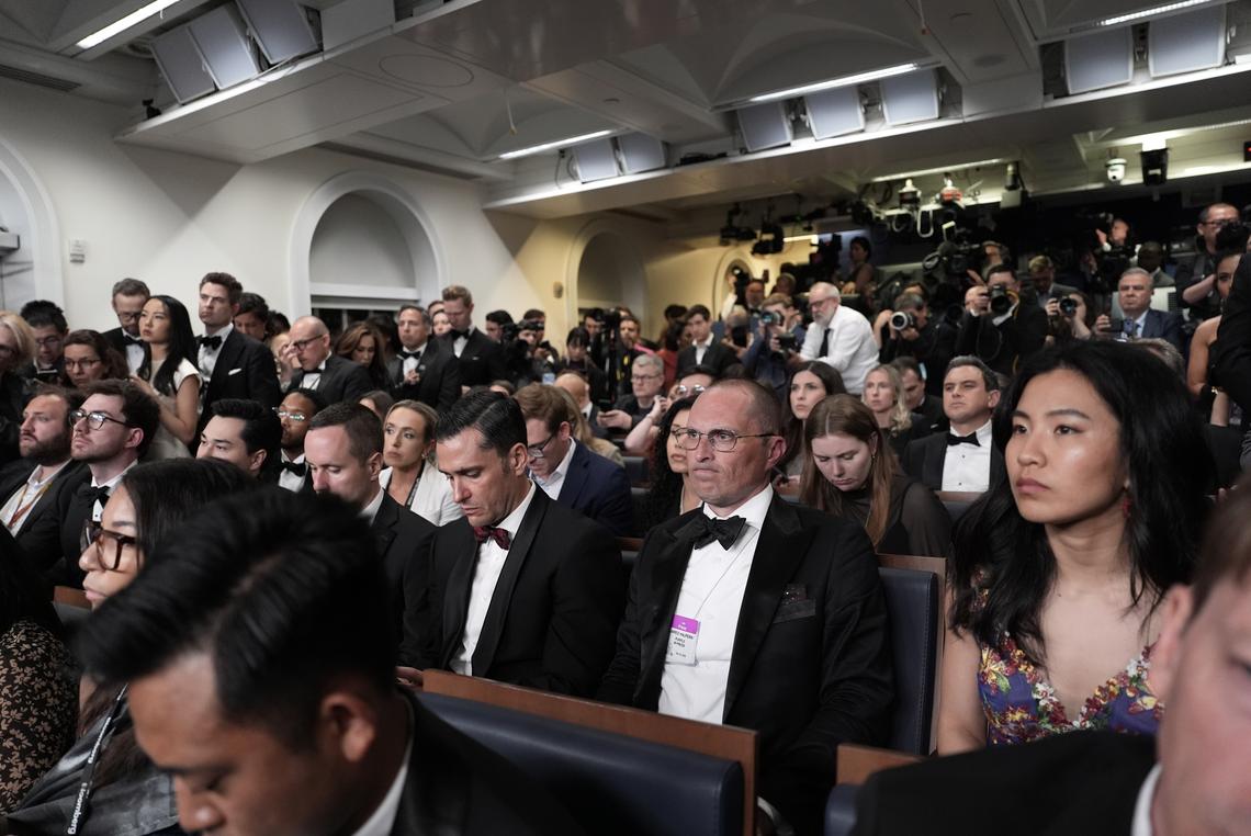 Reporters, many in formal wear, listen as President Donald Trump speaks at the White House after shots were fired during the White House Correspondents' Association dinner at the Washington Hilton in Washington on Saturday, April 25, 2026. Trump was rushed from the stage but was unharmed. (Salwan Georges/The New York Times)