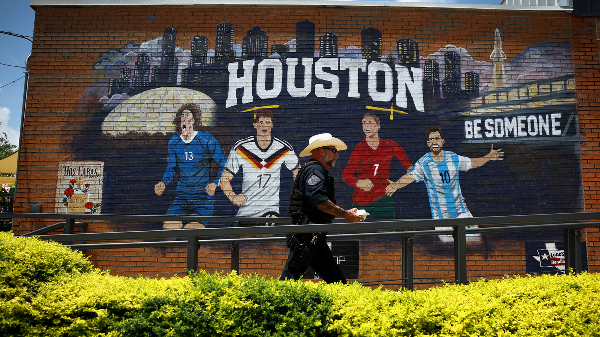 A member of the Sheriff department walks past a World Cup-themed mural in Houston, Texas, U.S. June 18, 2026. REUTERS/Phil Noble