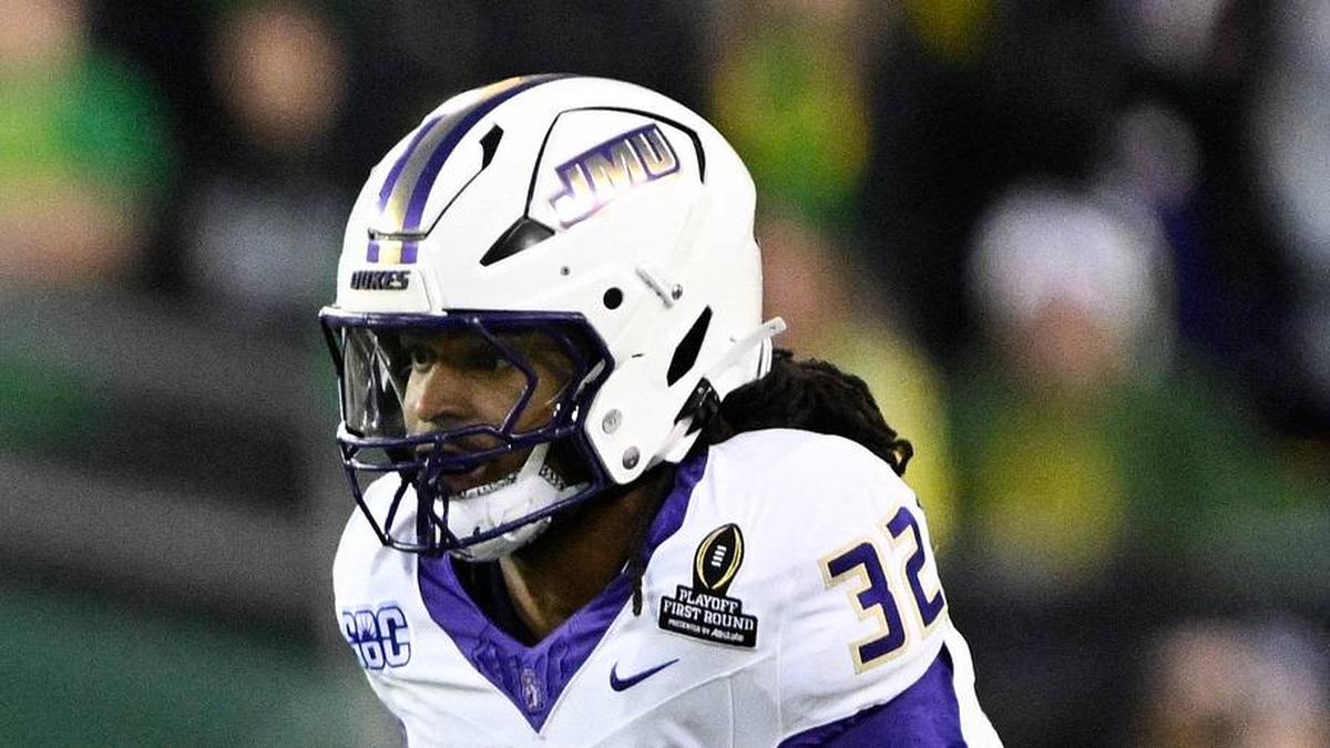  Dec 20, 2025; Eugene, OR, USA; Oregon Ducks wide receiver Jeremiah McClellan (11) runs after making a catch as James Madison Dukes defensive back DJ Barksdale (32) defends during the first quarter at Autzen Stadium. Mandatory Credit: Troy Wayrynen-Imagn Images | Troy Wayrynen-Imagn Images 
